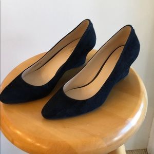 Black suede wedge heels.